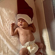 Jordan is registered to the contest to win money with this photo: baby, infant, diaper, santa_hat, sleeping, blanket, crib, cute, newborn, holiday, festive, soft, relaxed, child, indoors, resting, small, adorable, sleep, holiday_hat
