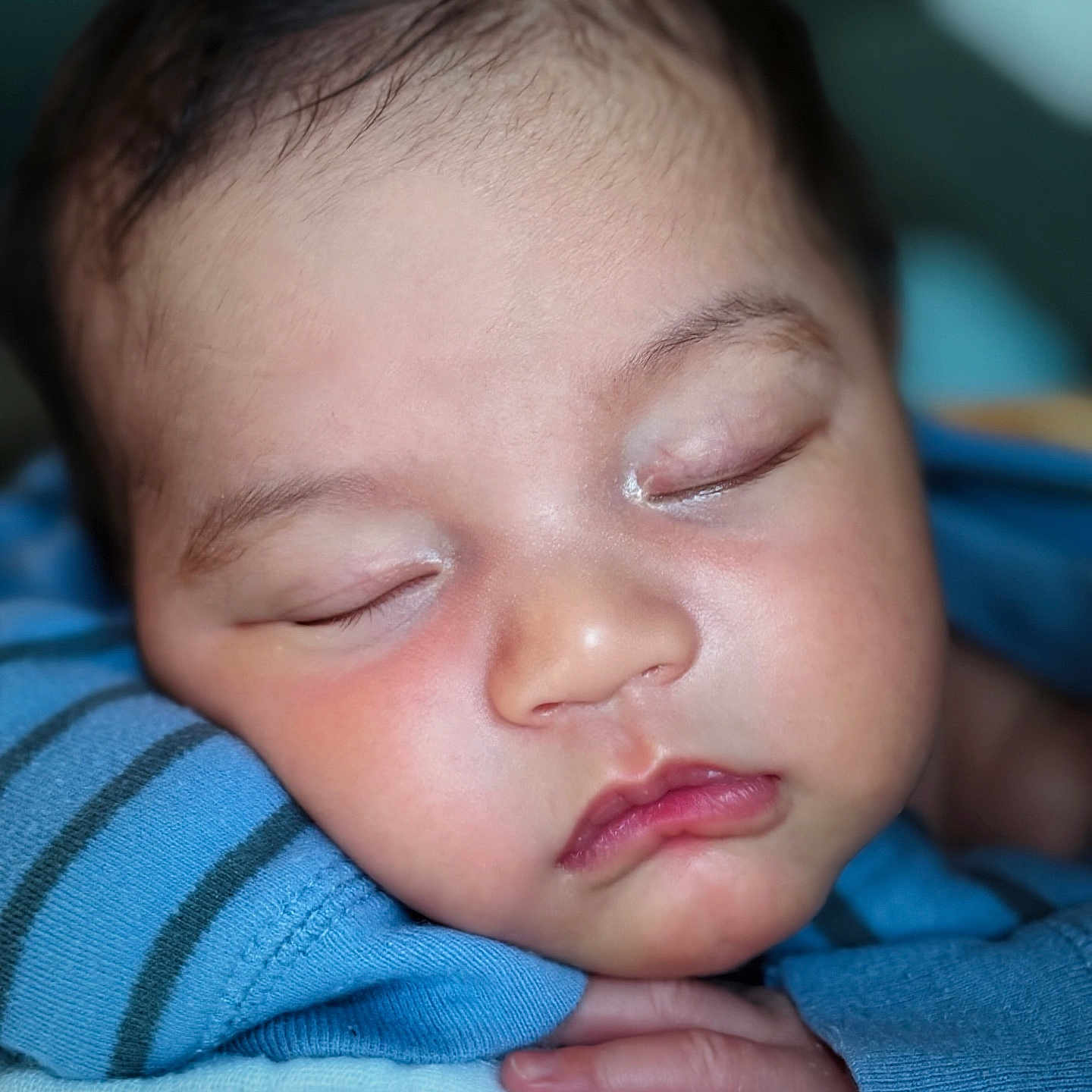 William is registered to the contest to win money with this photo: baby, blue_clothing, calm, child, closeup, cozy, cute, eyelids, face, gentle, hand, indoors, infant, newborn, peaceful, portrait, resting, skin, sleeping, soft_light