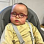 child, baby, toddler, glasses, pink_glasses, round_glasses, highchair, harness, seatbelt, yellow_clothing, chubby_cheeks, indoor, window, portrait, neutral_expression, skin, hair, photography, candid, furniture