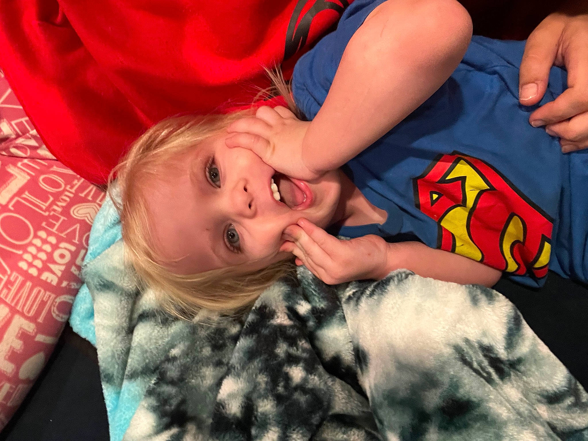 Jasper joined the competition — help win amazing prizes! baby, carmine, child, facial_expression, fictional_character, finger, fun, gesture, happy, justice_league, mouth, nail, pattern, person, room, sitting, smile, superman, t_shirt, toddler