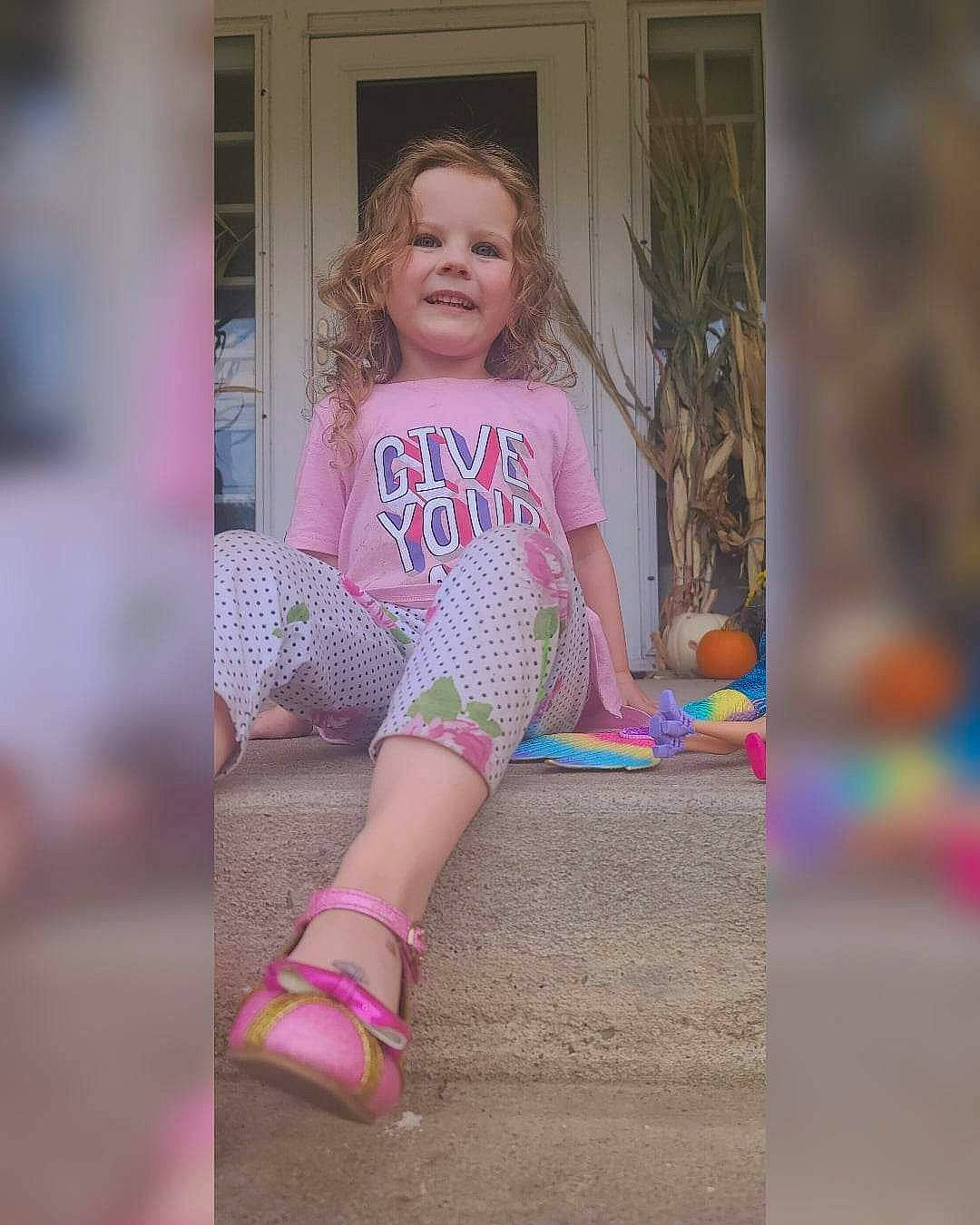 Lilah joined the competition — help win amazing prizes! blond, calf, denim, electric_blue, grass, hair, happy, human_leg, joy, knee, long_hair, magenta, pattern, person, pink, sleeve, smile, sock, t_shirt, thigh