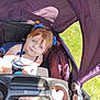 baby, baby_seat, blue_bows, blue_eyes, canopy, child, curious_expression, cute, grass, infant, outdoor, person, pink_glasses, portrait, purple, seatbelt, stroller, summer, sunlight, toy