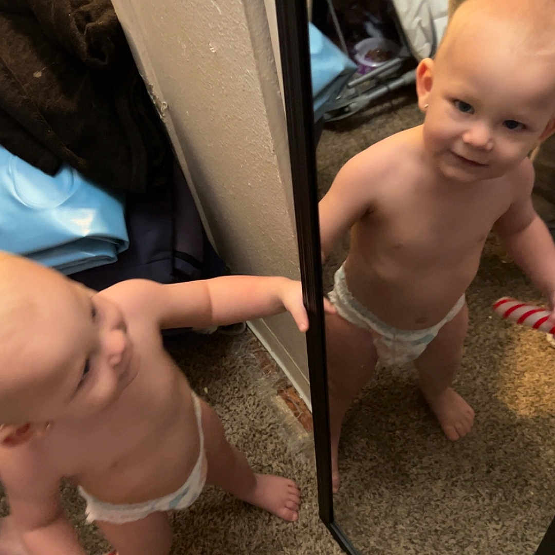 Aostin joined the competition — help win amazing prizes! barefoot, carpet, child, curious, diaper, face, foot, hand, holding, household, indoor, mirror, patriotic, person, red_white_blue, reflection, room, standing, toddler, toy