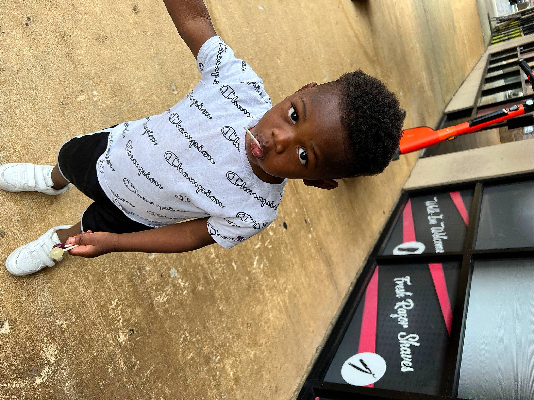 Benjamin is registered to the contest to win money with this photo: child, concrete, denim, elbow, eyewear, fun, happy, human_leg, joint, knee, leisure, person, public_event, recreation, sitting, sleeve, sports, sportswear, t_shirt, thigh