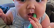Jaycie joined the competition — help win amazing prizes! baby, infant, child, teething_toy, blue_clothing, closeup, cute, chubby_cheeks, hand, face, indoor, person, curious, polka_dot, sitting, skin, furniture, soft_light, teething, young
