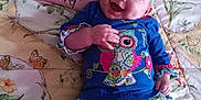 Gracelyn joined the competition — help win amazing prizes! baby, bedspread, blue_clothing, child, colorful, cute, floral_pattern, flower, happy, headband, indoors, infant, joyful, lying_down, owl_design, person, pillow, pink, smiling, soft_lighting