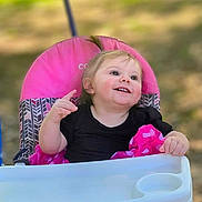 Gracelyn joined the competition — help win amazing prizes! toddler, child, stroller, pink, smile, outdoor, happy, baby, clothing, foot, seat, person, portrait, cute, playful, sunlight, nature, grass, summer, fun