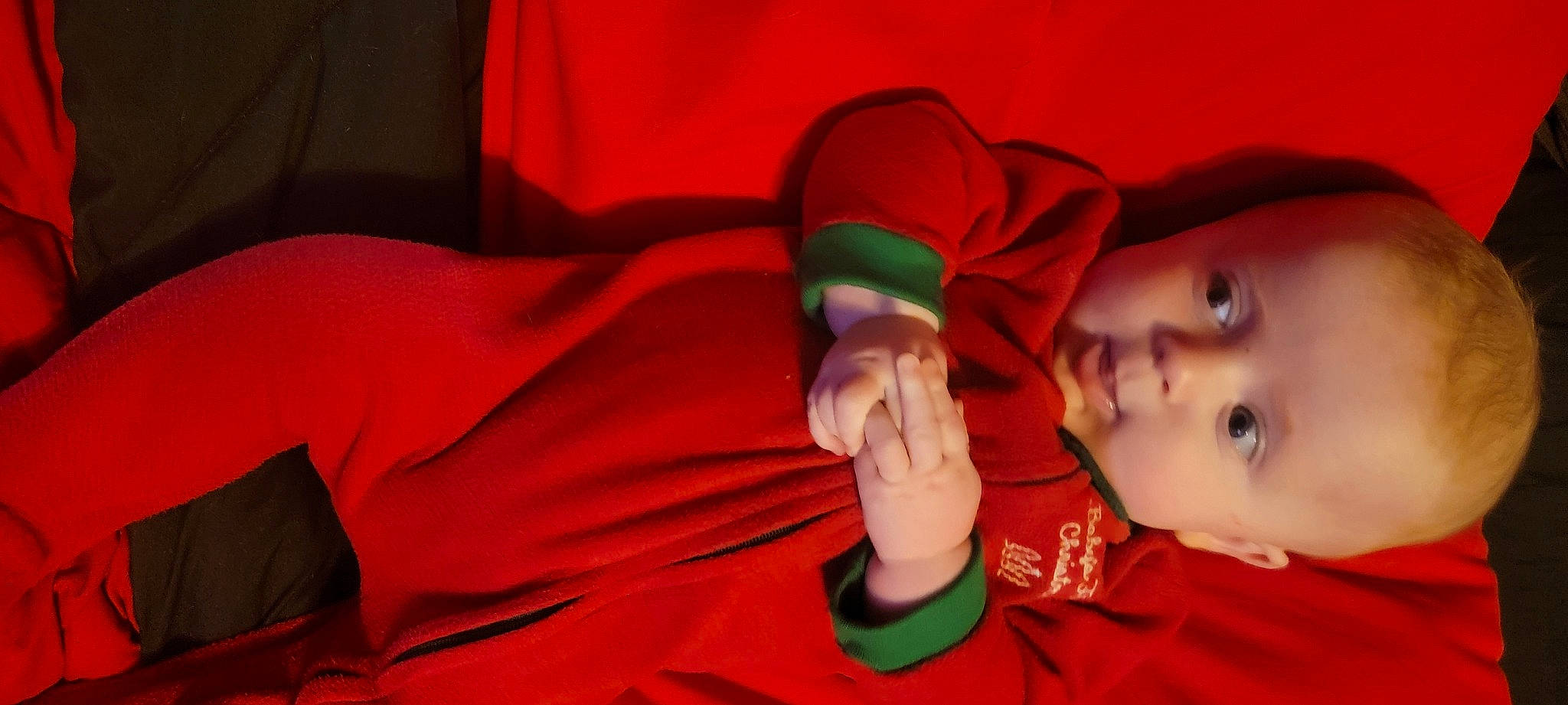 Lennon is registered to the contest to win money with this photo: baby, baby_toddler_clothing, cheek, child, comfort, elbow, eye, fun, gesture, happy, human_body, linens, mouth, nose, orange, person, sleeve, textile, thumb, toddler