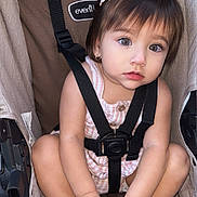 Isabella joined the competition — help win amazing prizes! toddler, child, stroller, baby, cute, curly_hair, flower_clip, hands, feet, straps, clothing, sitting, portrait, outdoor, expression, skin, footwear, baby_carrier, seat, cute_face