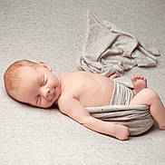 Nathaniel is registered to the contest to win money with this photo: baby, newborn, sleeping, infant, wrapped, blanket, soft_texture, peaceful, skin, head, face, lying_down, cute, rest, toddler, bare_skin, indoors, cozy, calm, portrait