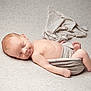 baby, newborn, sleeping, infant, wrapped, blanket, soft_texture, peaceful, skin, head, face, lying_down, cute, rest, toddler, bare_skin, indoors, cozy, calm, portrait