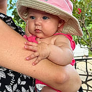 Elena participe au concours pour gagner de l'argent avec cette photo : baby, child, person, hat, pink, arm, hand, skin, outdoor, nature, leaf, greenery, holding, closeup, cute, infant, summer, sunhat, portrait, casual