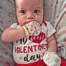 Raelyn joined the competition — help win amazing prizes! adorable, baby, celebration, child, close_up, cute, expressive_eyes, face, floral_blanket, heart, infant, lying_down, mittens, pink, polka_dots, portrait, red_clothing, soft_texture, valentines_day, white_shirt