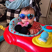 Raelyn joined the competition — help win amazing prizes! baby, blanket, blue, chair, child, cozy, cute, fashion, floor, indoor, minnie_mouse, person, plush_toy, portrait, red, reflection, sunglasses, toy, walker, yellow