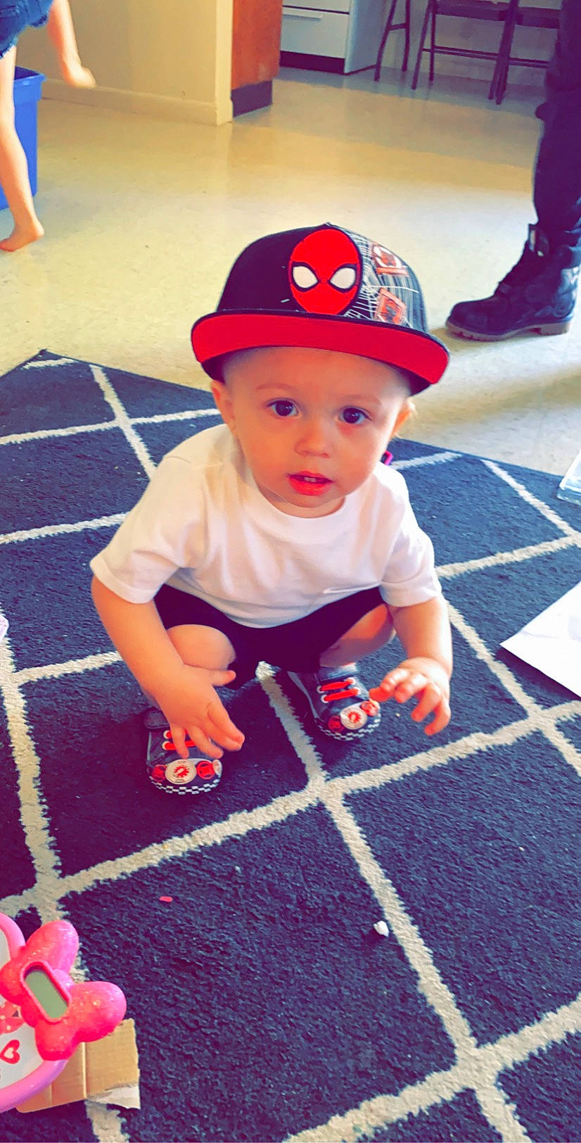 Sebastian is registered to the contest to win money with this photo: baby, cap, child, flooring, fun, games, hat, headgear, headwear, leisure, person, play, playground, recreation, red, sun_hat, toddler, vacation