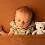 Gabriel participe au concours pour gagner de l'argent avec cette photo : adorable, baby, blanket, brown_background, child, closeup, cozy, cute, indoor, infant, knitted_clothing, newborn, peaceful, portrait, resting, sleeping, small_toy, soft_texture, teddy_bear, warm_colors