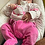 baby, sleeping, pacifier, pink_clothing, sweater, cushion, stars, pattern, infant, cute, cozy, indoor, child, resting, soft, hand, footed_pants, face, newborn, peaceful