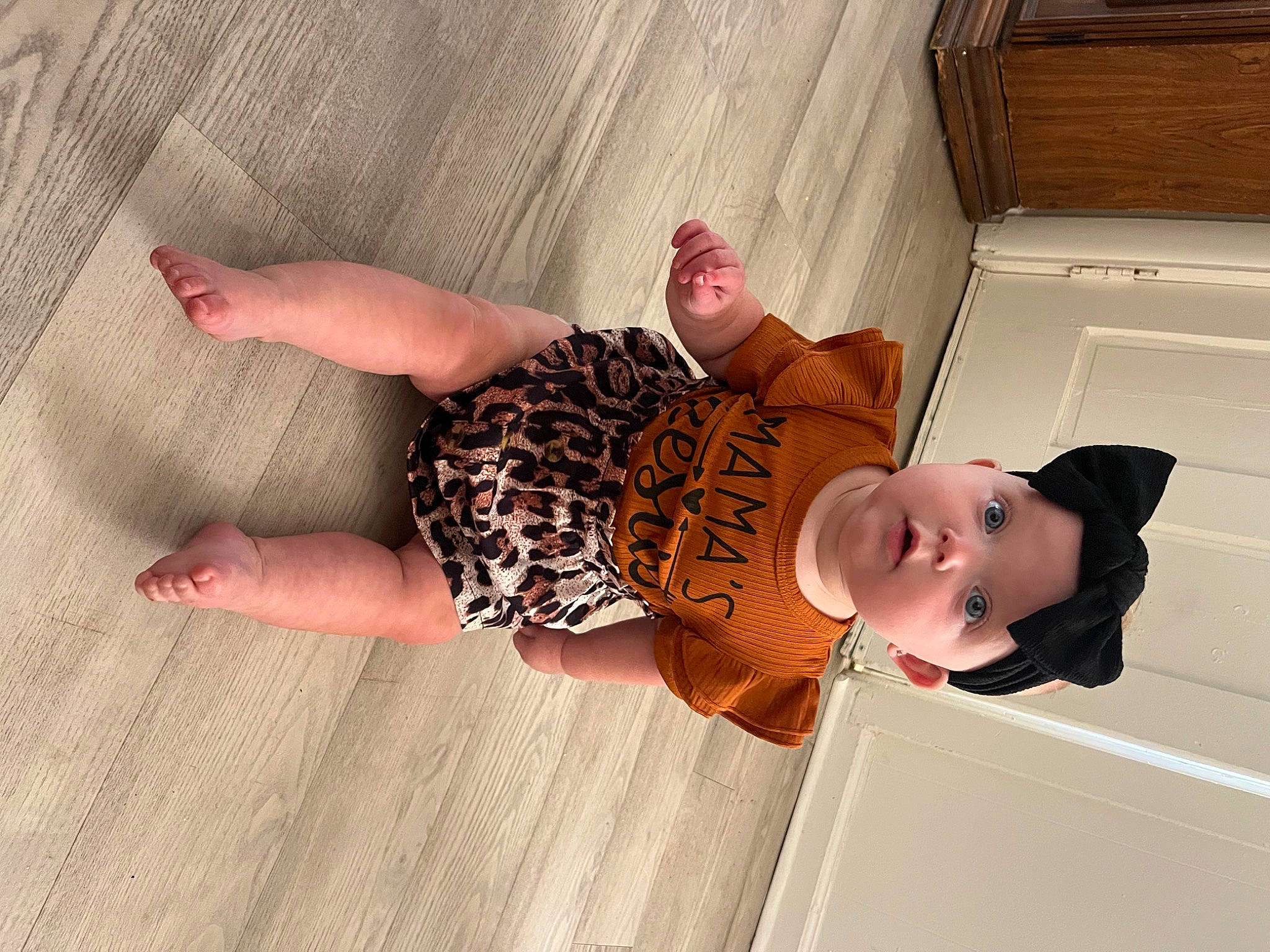 Adalynn is registered to the contest to win money with this photo: baby, baby_products, baby_toddler_clothing, child, comfort, foot, happy, hardwood, headwear, human_leg, linens, pattern, person, pink, room, sleeve, sock, surprise, thigh, thumb