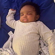 Azalea is registered to the contest to win money with this photo: baby, infant, sleeping, onesie, blanket, bed, blue_sheet, closed_eyes, face, cheeks, hand, cozy, portrait, nursery_item, soft_texture, pajamas, cute, lying_down, dark_hair, peaceful