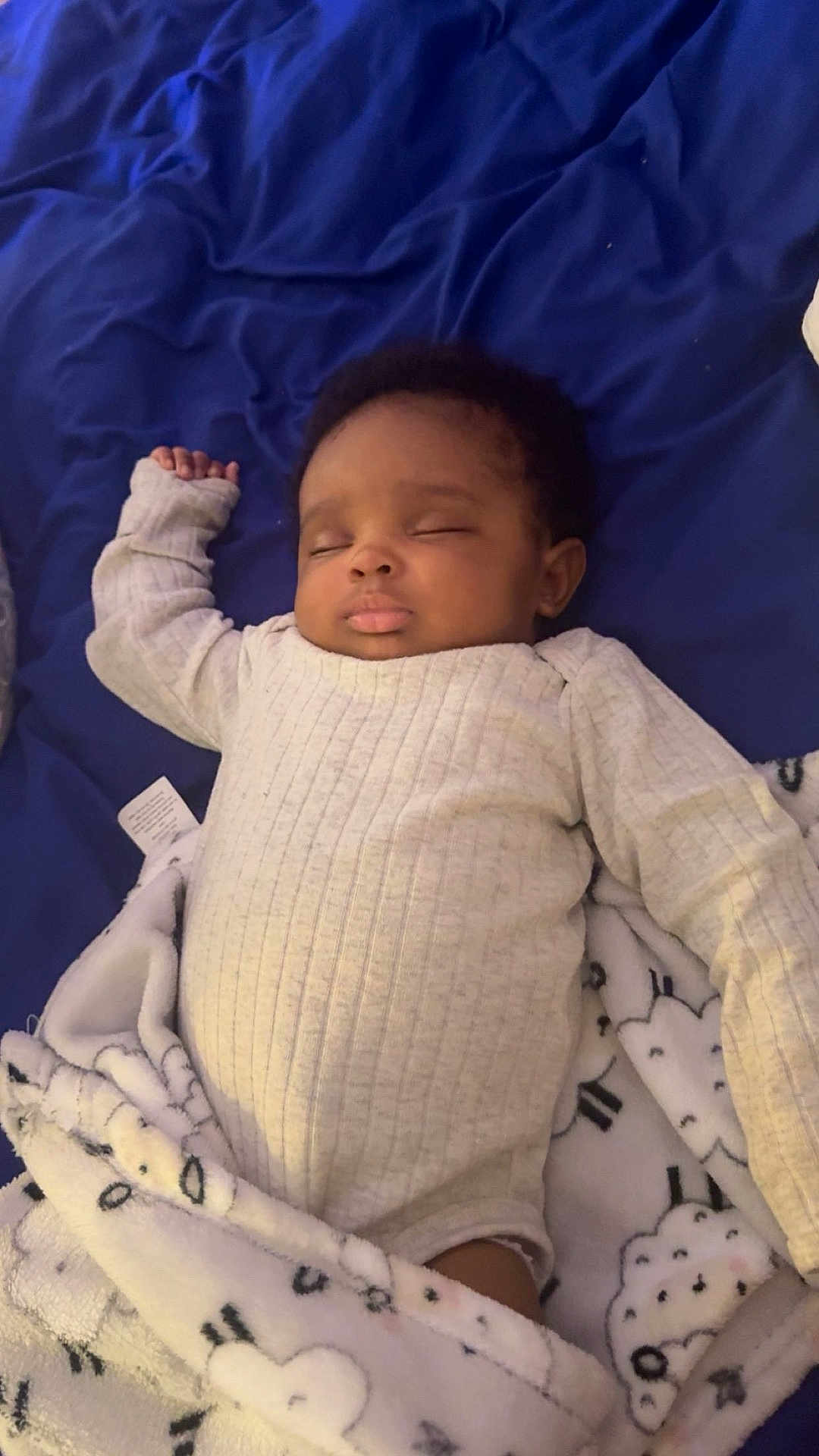 Azalea is registered to the contest to win money with this photo: baby, infant, sleeping, onesie, blanket, bed, blue_sheet, closed_eyes, face, cheeks, hand, cozy, portrait, nursery_item, soft_texture, pajamas, cute, lying_down, dark_hair, peaceful