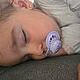 child, sleeping, pacifier, face, hand, pajamas, bedtime, closeup, rest, peaceful, young, indoors, comfort, soft, hair, earring, relaxation, skin, nap, cozy
