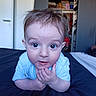 Mickaël participe au concours pour gagner de l'argent avec cette photo : baby, infant, child, face, blue_eyes, hands, bed, bedroom, curious, clothing, indoor, person, portrait, tousled_hair, lying_down, young_child, furniture, door, shelf, soft_light