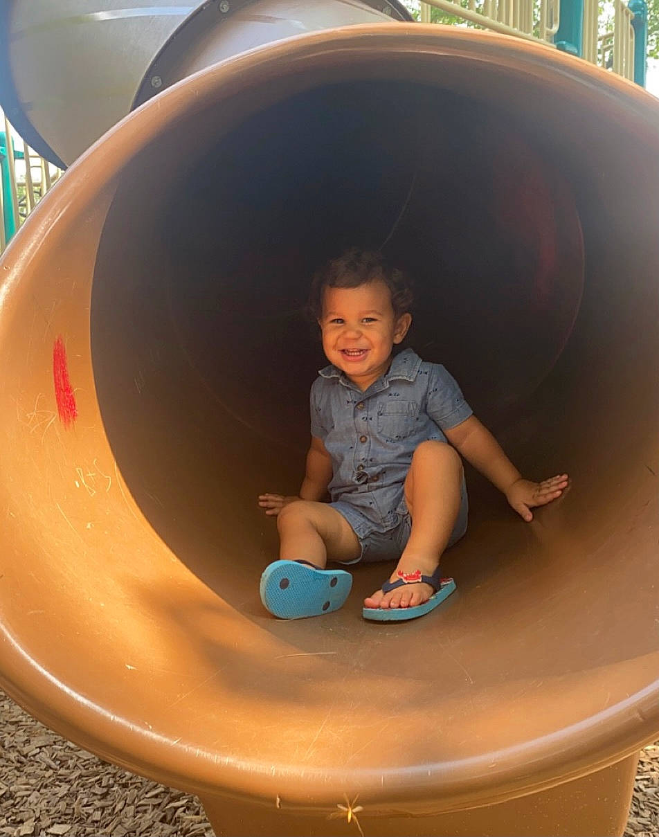 Leo James joined the competition — help win amazing prizes! automotive_tire, baby_toddler_clothing, child, circle, city, eye, fun, human_settlement, joy, leisure, mammal, organ, outdoor_play_equipment, person, playground, product, public_space, recreation, shorts, smile