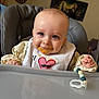 Ayden a rejoint le concours — aidez-le/la à gagner de superbes lots ! baby, high_chair, bib, food_stains, blue_eyes, smiling, indoor, toy, beads, face, child, person, clothing, feeding, happy, cute, home, furniture, messy, portrait