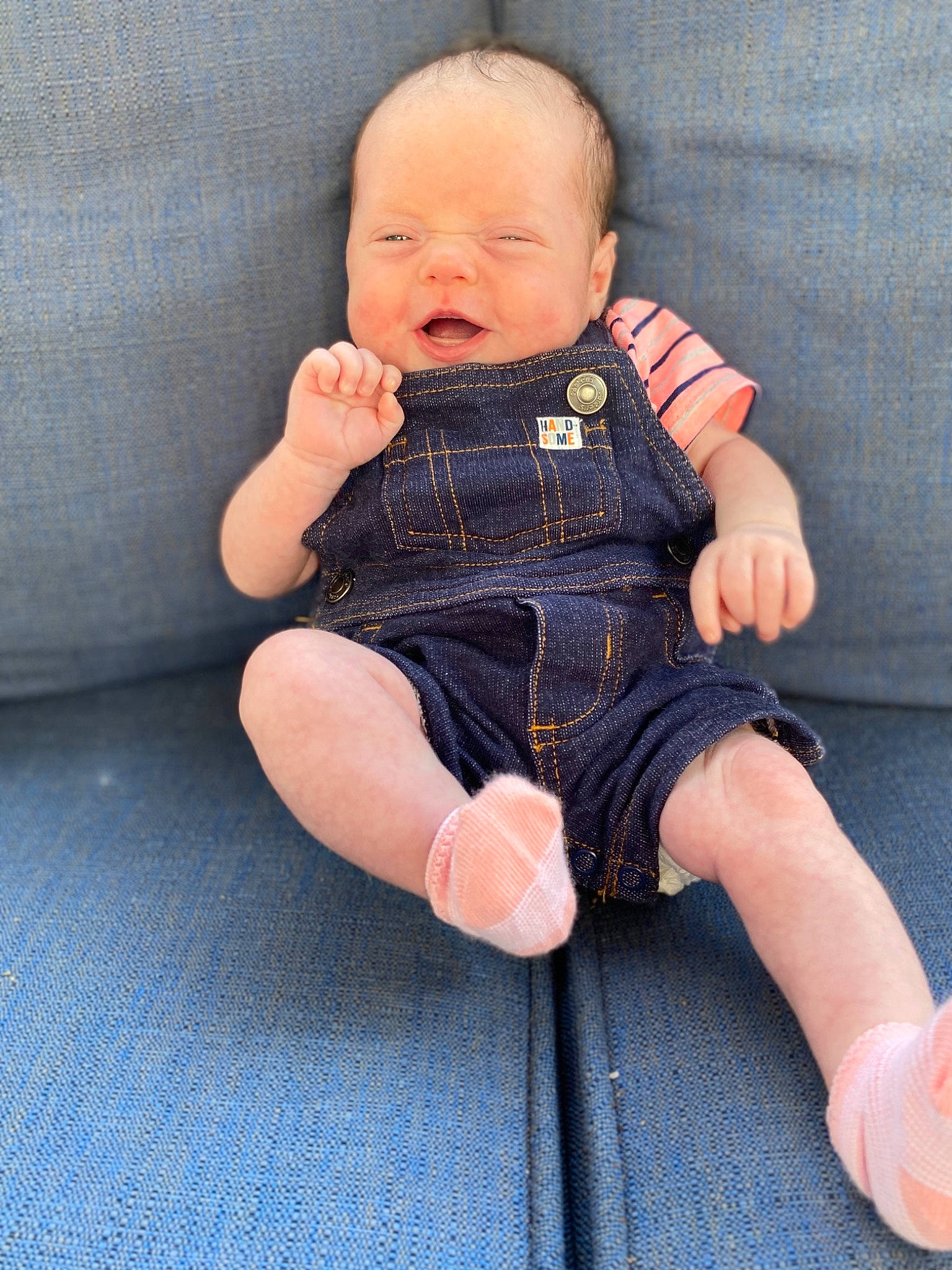 Harlyn is registered to the contest to win money with this photo: arm, baby, baby_toddler_clothing, cheek, child, denim, finger, hand, jeans, leg, pattern, person, sitting, skin, thumb, toddler