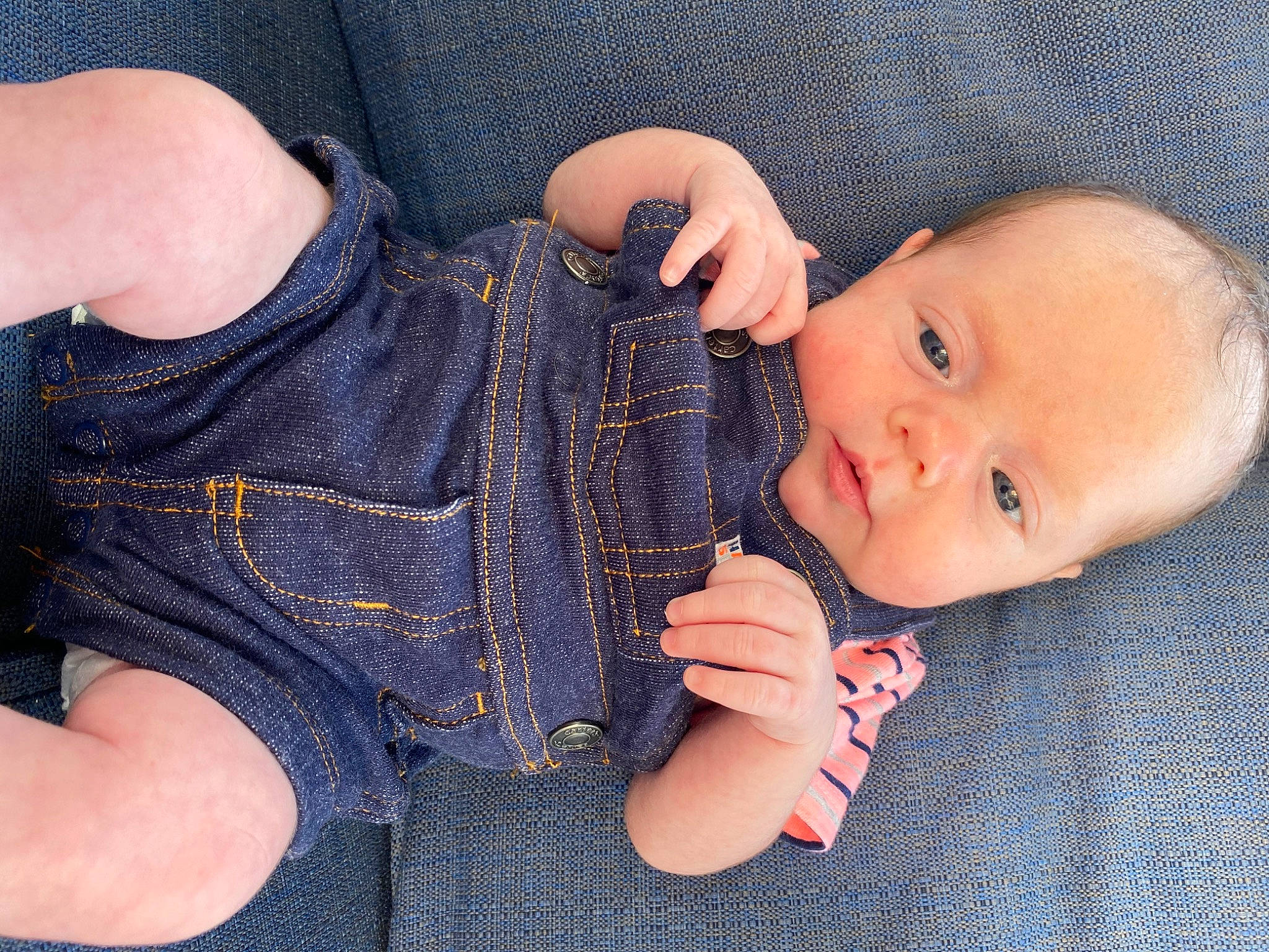 Harlyn is registered to the contest to win money with this photo: arm, baby, cheek, child, denim, eye, finger, gesture, hand, jeans, leg, lip, mouth, muscle, nail, person, sitting, skin, textile, thumb
