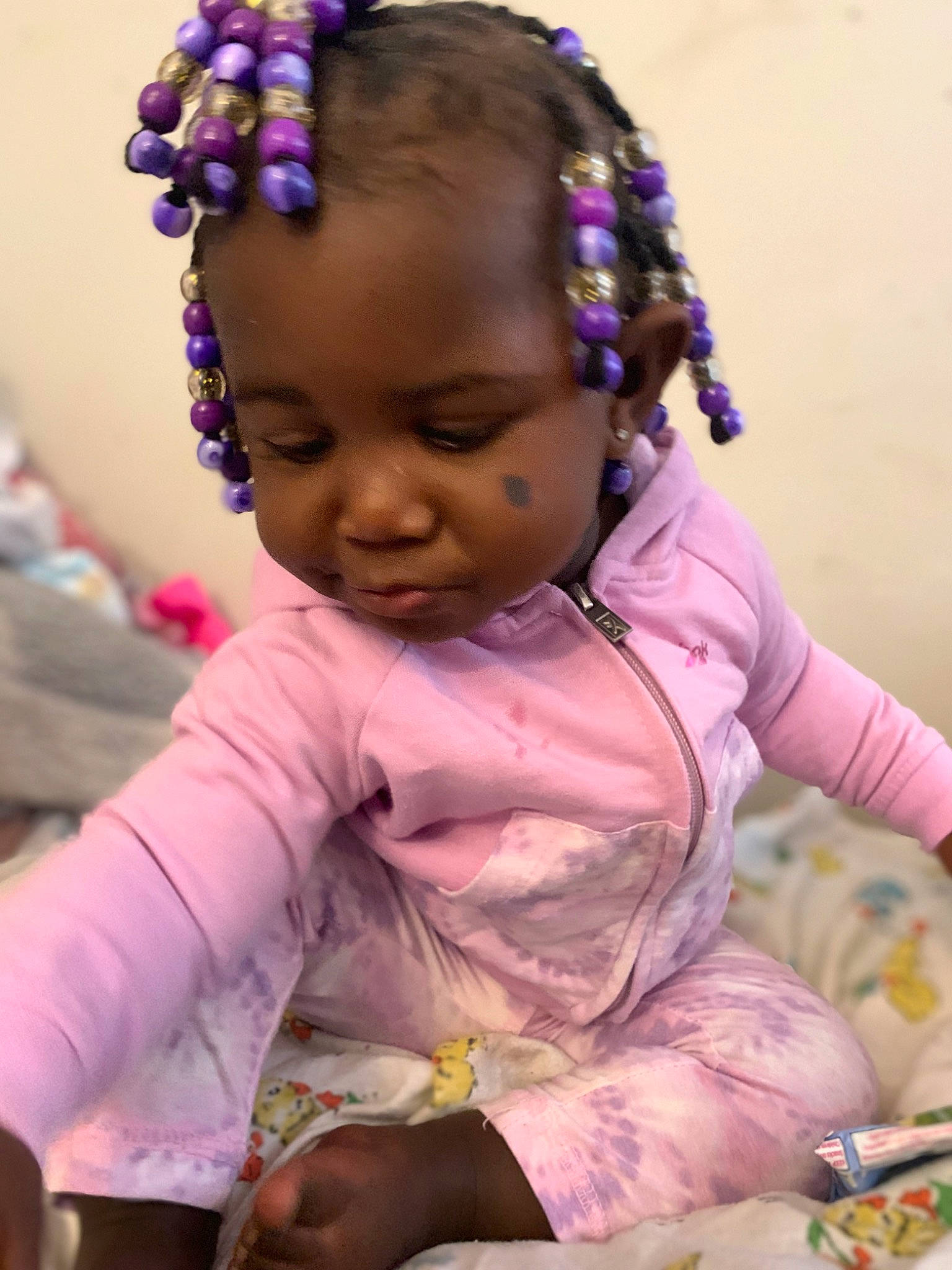 Araya is registered to the contest to win money with this photo: baby, baby_toddler_clothing, cheek, child, event, facial_expression, fashion_accessory, fun, happy, headband, headpiece, human, magenta, person, pink, play, purple, sitting, skin, toddler
