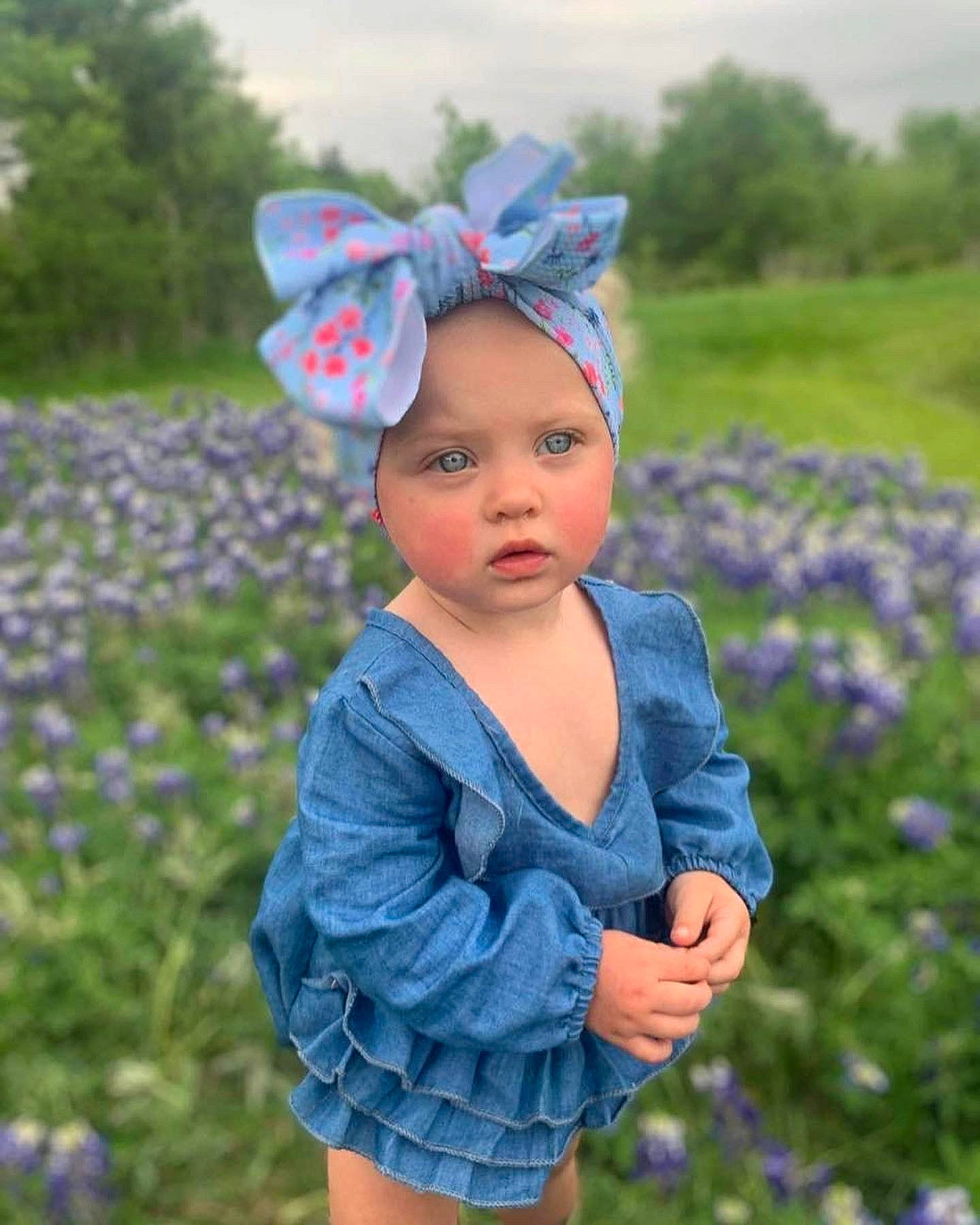 Ryklyn is registered to the contest to win money with this photo: azure, baby, baby_toddler_clothing, blue, botany, eye, flower, grass, grassland, happy, head, headwear, meadow, outerwear, people_in_nature, person, petal, plant, purple, summer
