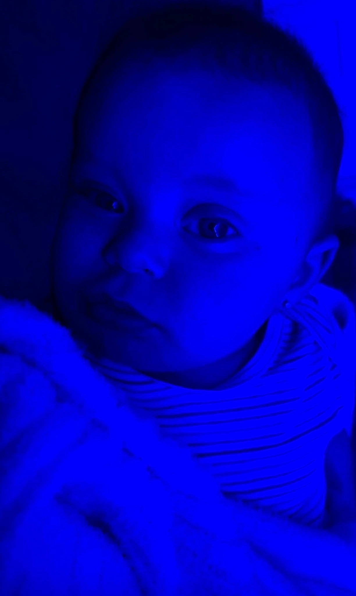 Koby Il is registered to the contest to win money with this photo: azure, baby, baby_toddler_clothing, blue, cheek, child, close_up, darkness, electric_blue, flash_photography, fun, iris, magenta, person, purple, room, sitting, smile, space, toddler