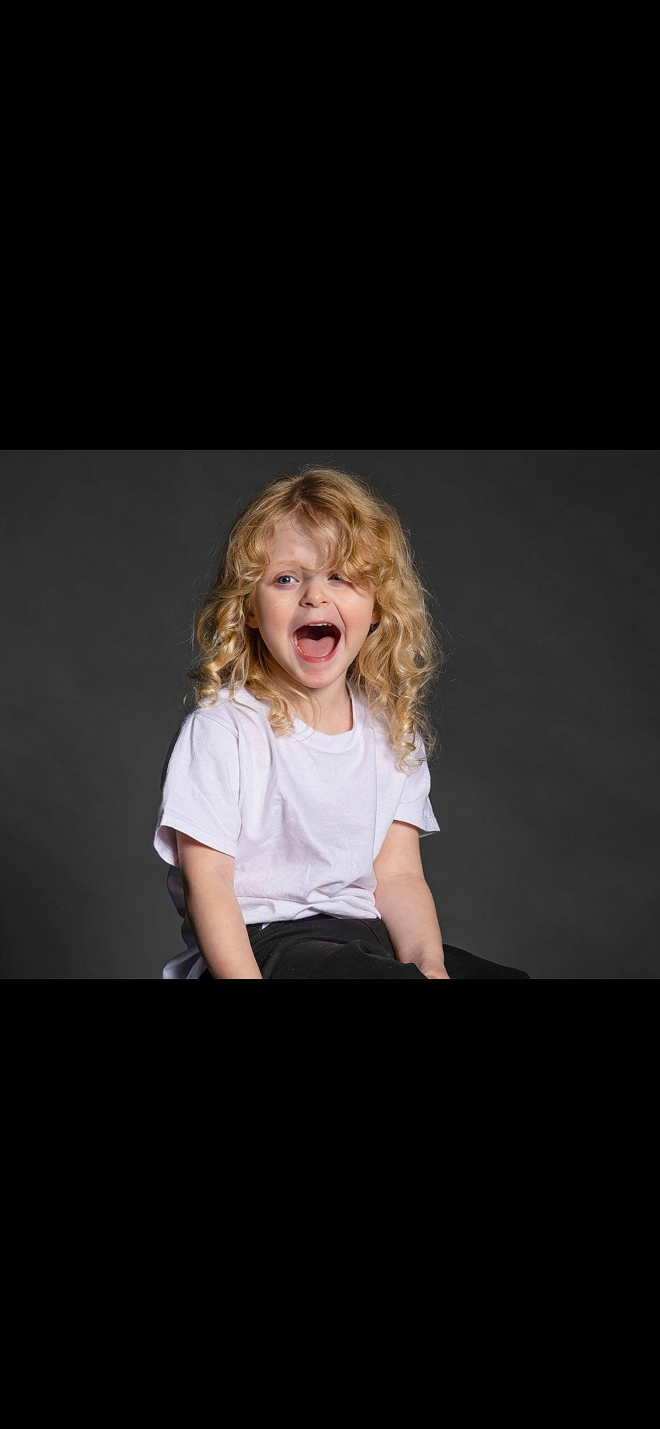 Journee is registered to the contest to win money with this photo: blond, cheek, child, darkness, entertainment, event, fashion_design, flash_photography, fun, happy, magenta, person, portrait, portrait_photography, sitting, sleeve, smile, step_cutting, t_shirt, toddler