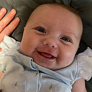Elizabeth joined the competition — help win amazing prizes! baby, smiling, infant, face, hand, clothing, blue_outfit, quilt, cute, happy, eyes, child, skin, person, lying_down, soft_texture, indoors, closeup, chick_design, apparel