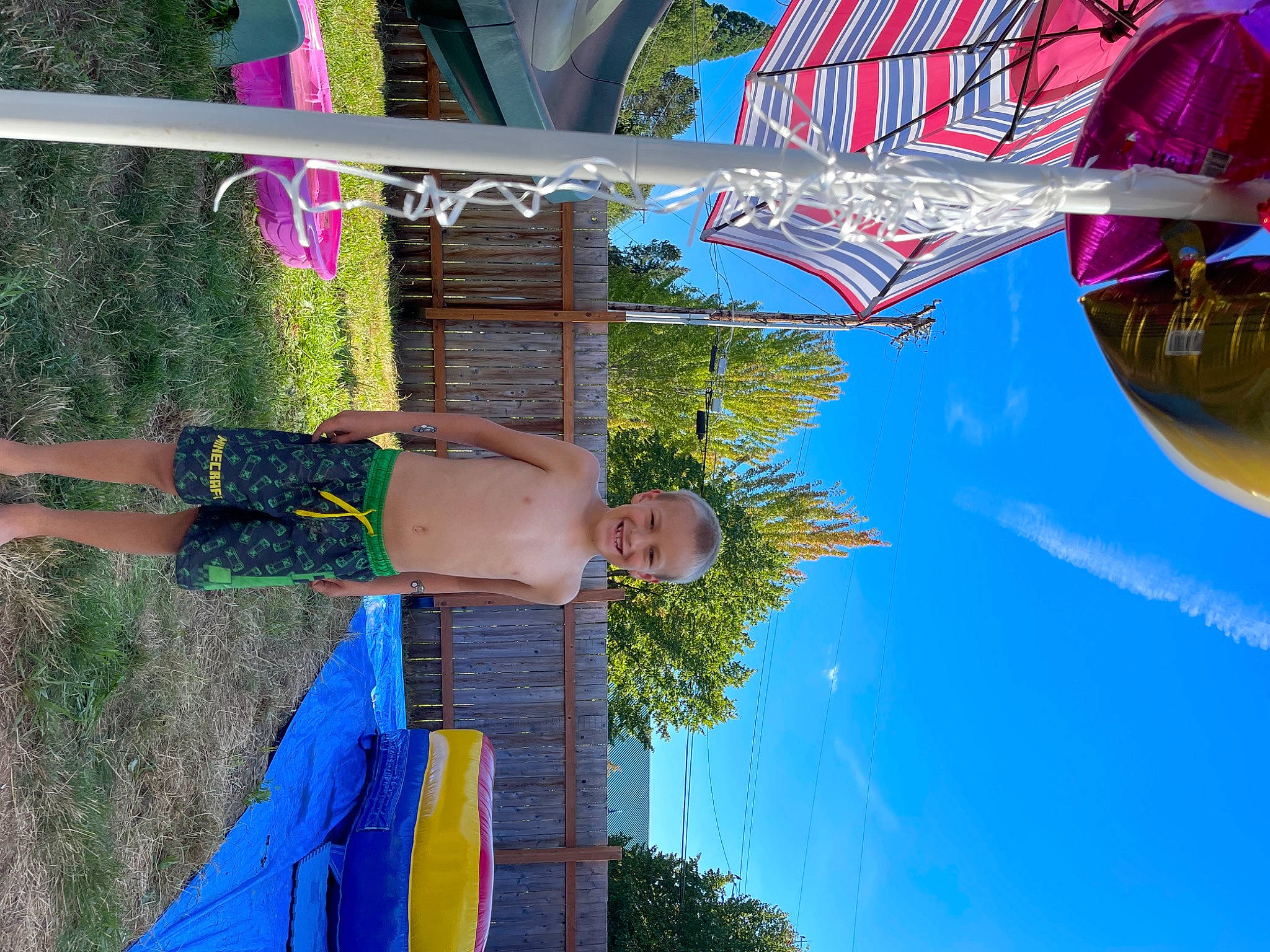 Tyson is registered to the contest to win money with this photo: blue, electric_blue, fun, green, joy, leisure, line, magenta, nonbuilding_structure, person, photograph, plant, pole, recreation, sky, smile, snapshot, summer, travel, tree