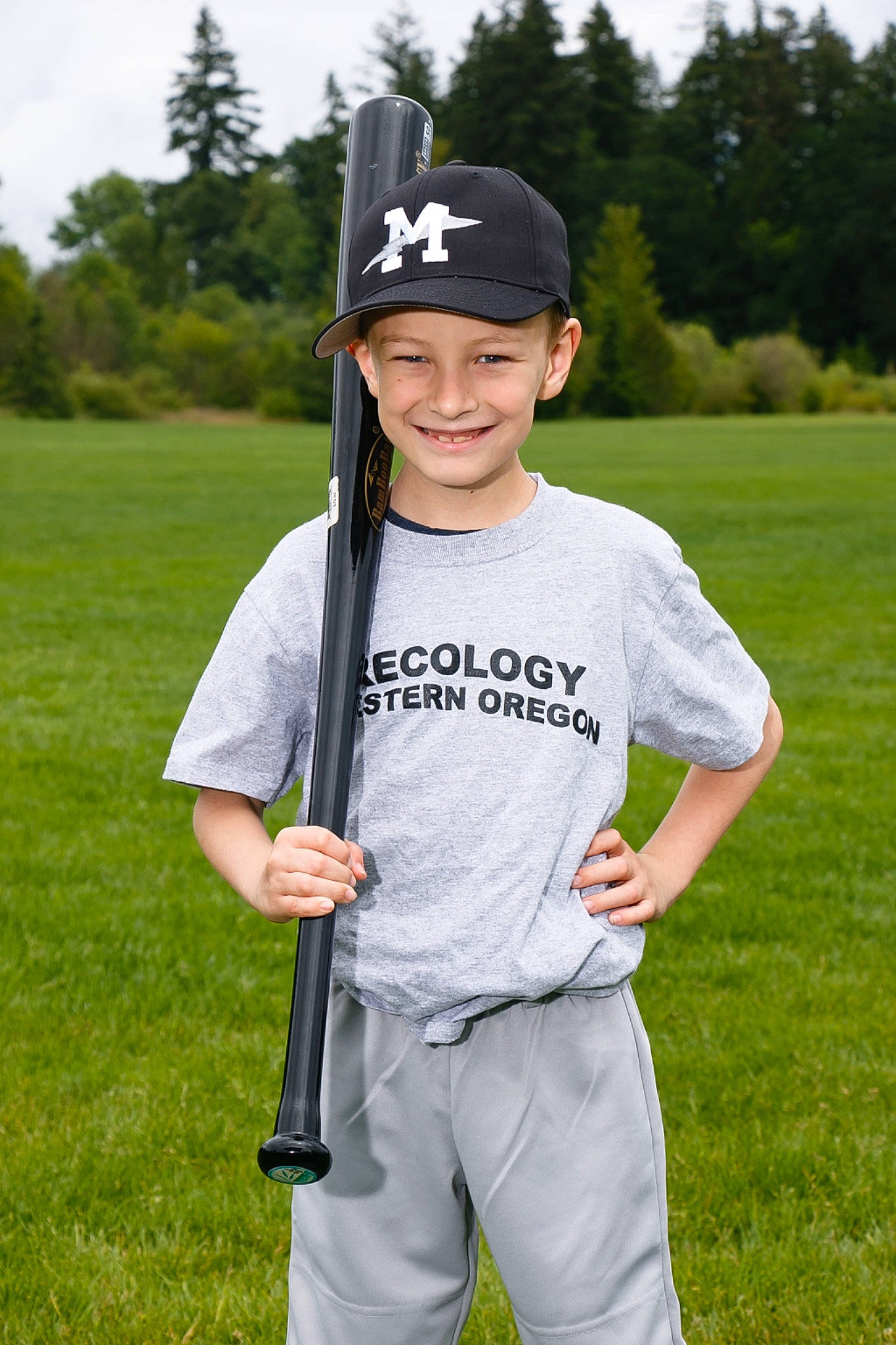 Tyson is registered to the contest to win money with this photo: baseball_bat, baseball_cap, baseball_equipment, baseball_player, bat_and_ball_games, cap, gesture, grass, headwear, joy, outerwear, person, personal_protective_equipment, player, recreation, sky, sleeve, smile, sports_equipment, sports_gear