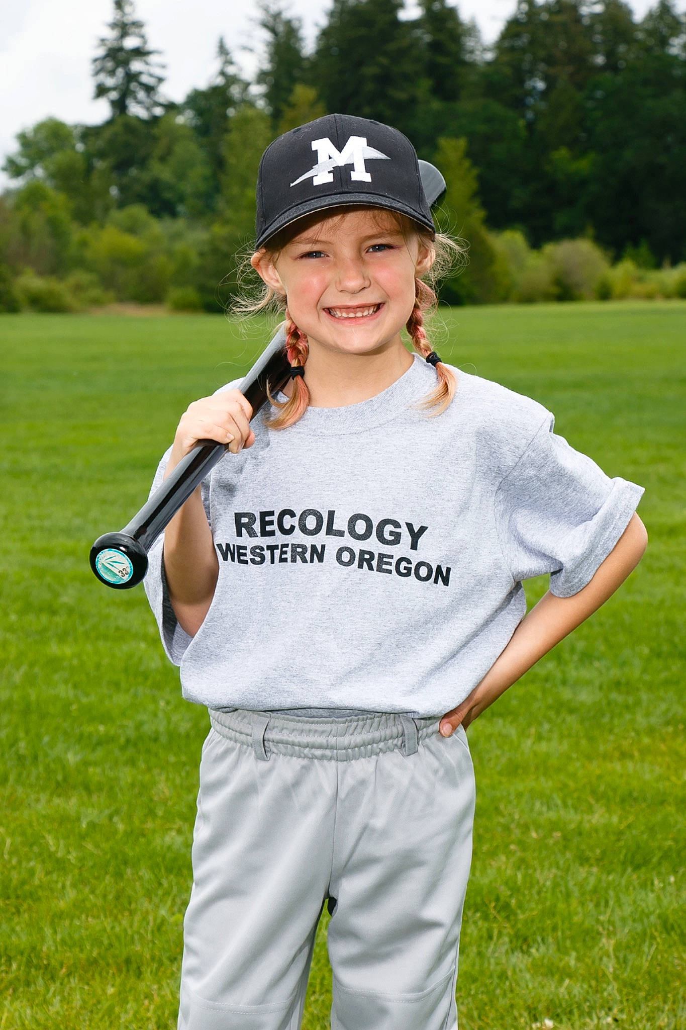 Brooklynn is registered to the contest to win money with this photo: baseball_cap, cap, competition_event, face, gesture, grass, grassland, happy, headgear, headwear, joy, outdoor_recreation, person, player, recreation, sky, sleeve, smile, sports_equipment, sports_gear
