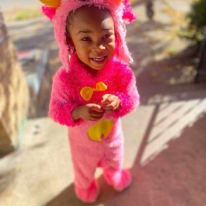 Athena joined the competition — help win amazing prizes! baby, babylaughing, cap, clothing, coat, costume, dress, face, festival, hair, happy, hat, head, person, photography, pinkhair, portrait, sleeve, smile, standing