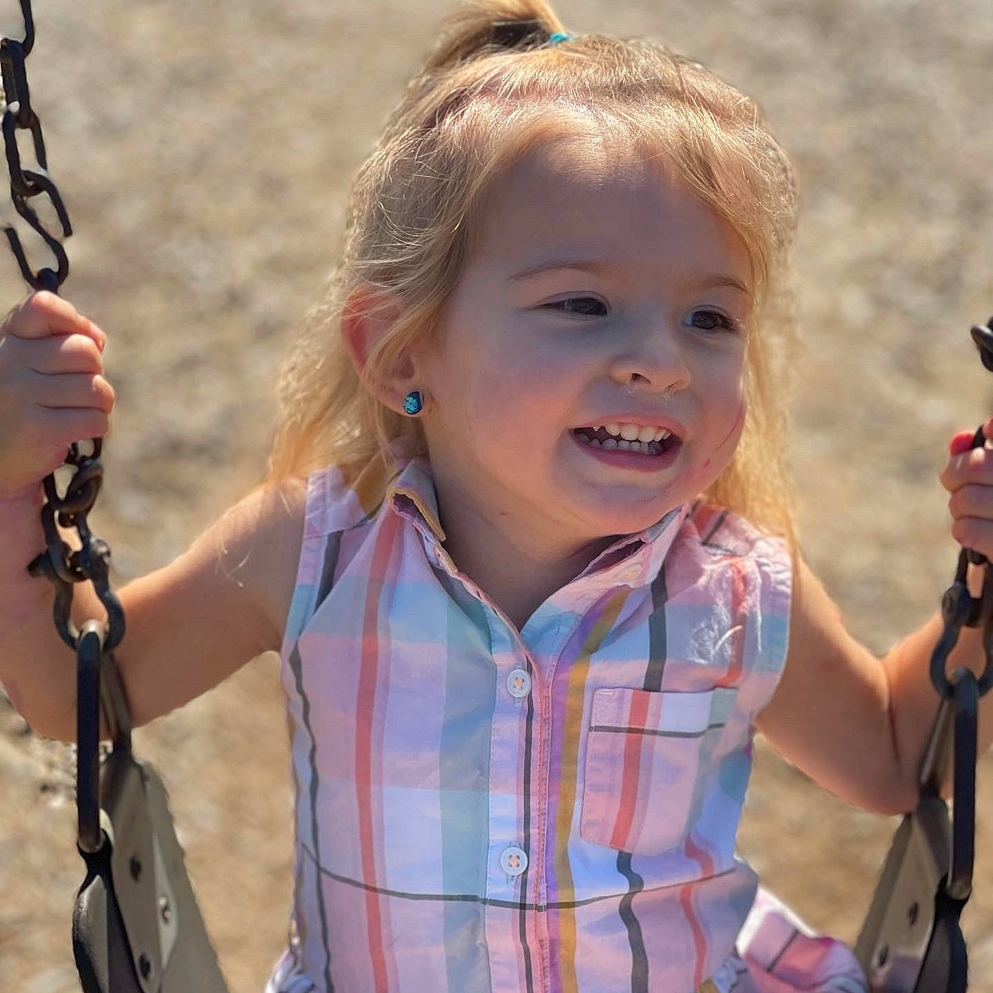 Sage is registered to the contest to win money with this photo: blond, child, facial_expression, finger, fun, grass, hand, happy, leisure, people_in_nature, person, photograph, plaid, recreation, skin, smile, summer, tartan, toddler, travel