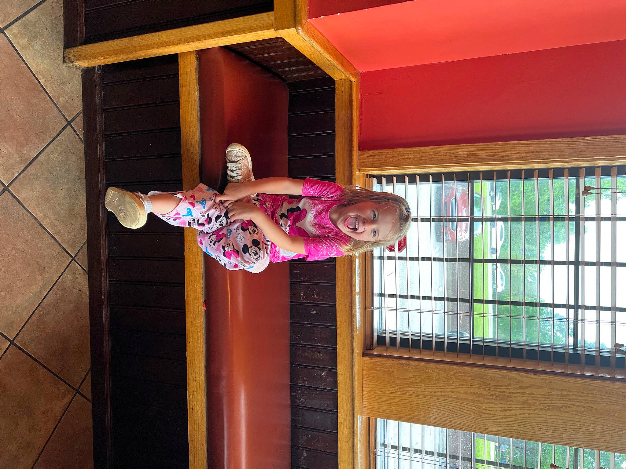 Sage is registered to the contest to win money with this photo: ceiling, child, flooring, fun, glass, hardwood, interior_design, leisure, magenta, person, pink, plant, plywood, room, smile, toddler, tree, window, wood, wood_stain