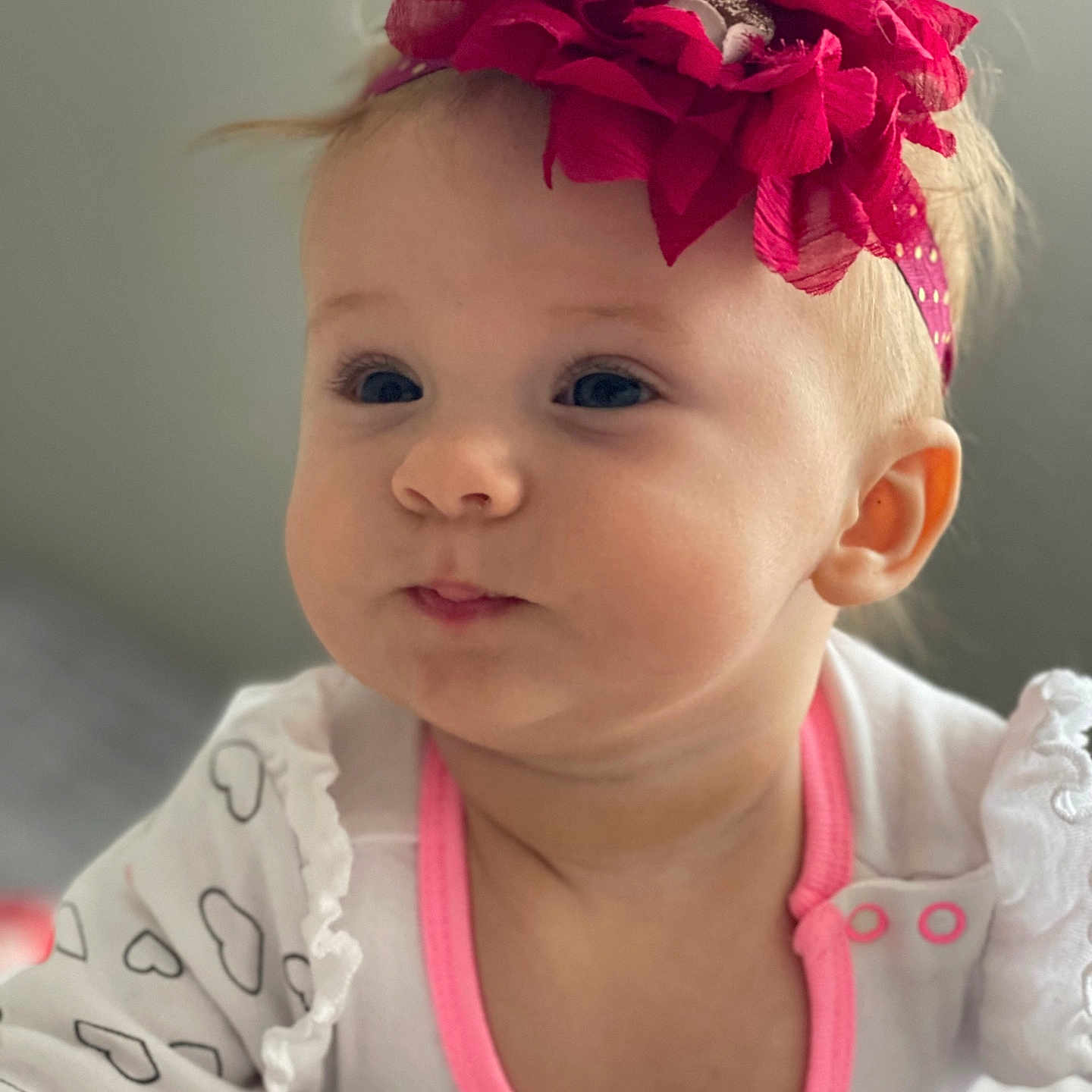 Leila joined the competition — help win amazing prizes! baby, cheeks, child, closeup, clothing, cute, expression, face, flower, headband, heart, indoor, infant, pattern, person, pink, portrait, soft_focus, white, young