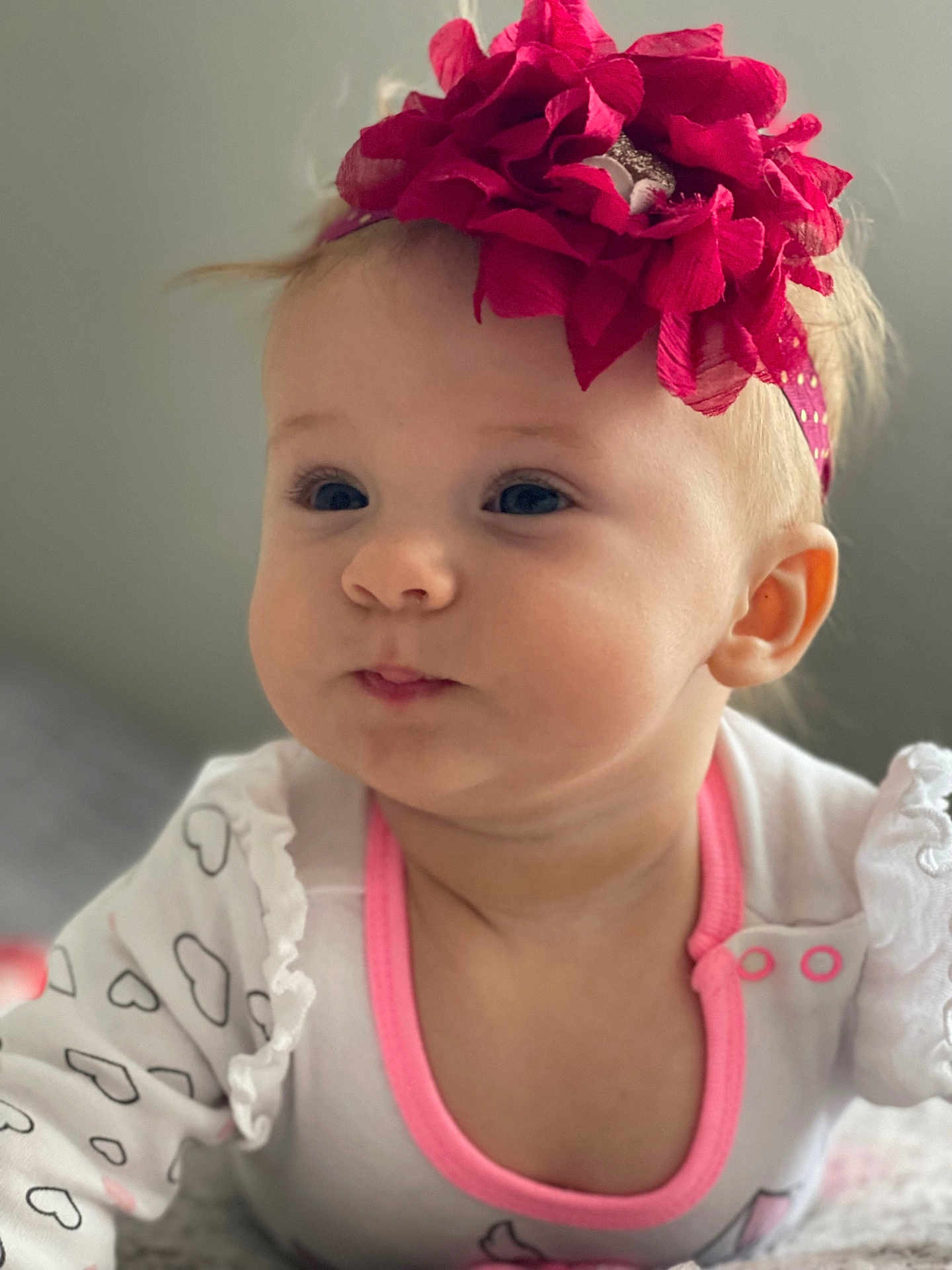 Leila joined the competition — help win amazing prizes! baby, cheeks, child, closeup, clothing, cute, expression, face, flower, headband, heart, indoor, infant, pattern, person, pink, portrait, soft_focus, white, young