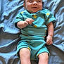 Michael Xavier Weems joined the competition — help win amazing prizes! baby, bed_sheet, blue_clothing, cheeky_expression, child, cute, drool, fabric, happy, human, indoors, infant, lying_down, relaxed, shirt, shorts, skin, small_hands, smiling, texture