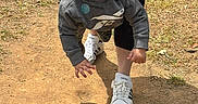 Jaden is registered to the contest to win money with this photo: child, toddler, swing, playground, outdoor, smile, happy, person, sneakers, adidas, hoodie, adult_hands, shadow, dirt_path, grass, sunlight, casual_clothing, fun, playing, nature