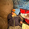 Jordin is registered to the contest to win money with this photo: baby, beanie, blue, couch, clothing, cozy, face, furniture, home, laundry_basket, nap, person, pants, resting, sitting, toddler, towel, warm, zipper, hoodie