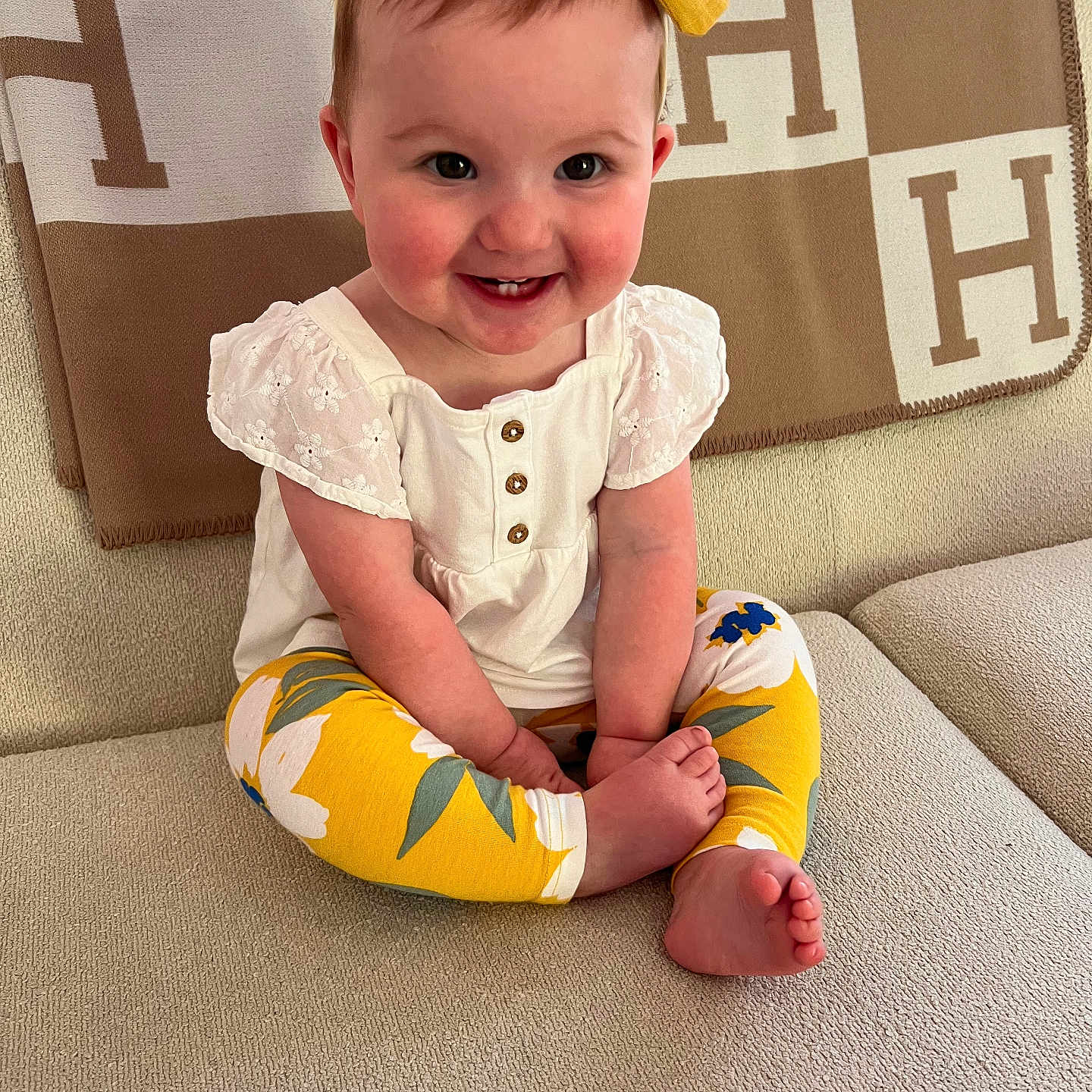 Eloise joined the competition — help win amazing prizes! accessories, baby, ball, clothing, couch, cushion, face, football, furniture, happy, head, homedecor, pants, person, photography, portrait, shorts, sitting, smile, t_shirt