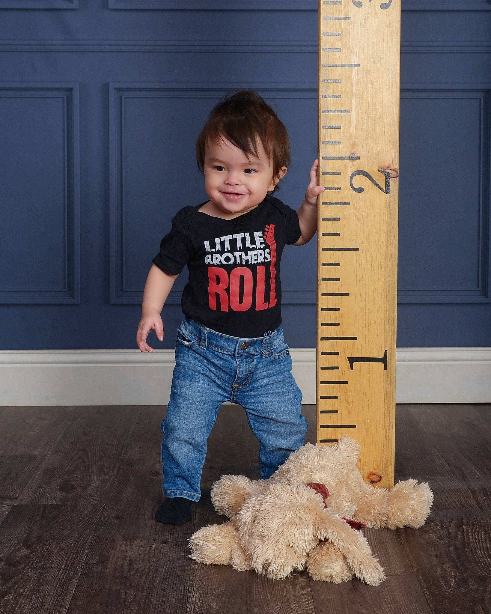 Oscar is registered to the contest to win money with this photo: companion_dog, denim, door, electric_blue, floor, flooring, font, fun, fur, happy, hardwood, jeans, joy, person, sleeve, smile, standing, t_shirt, toddler, toy