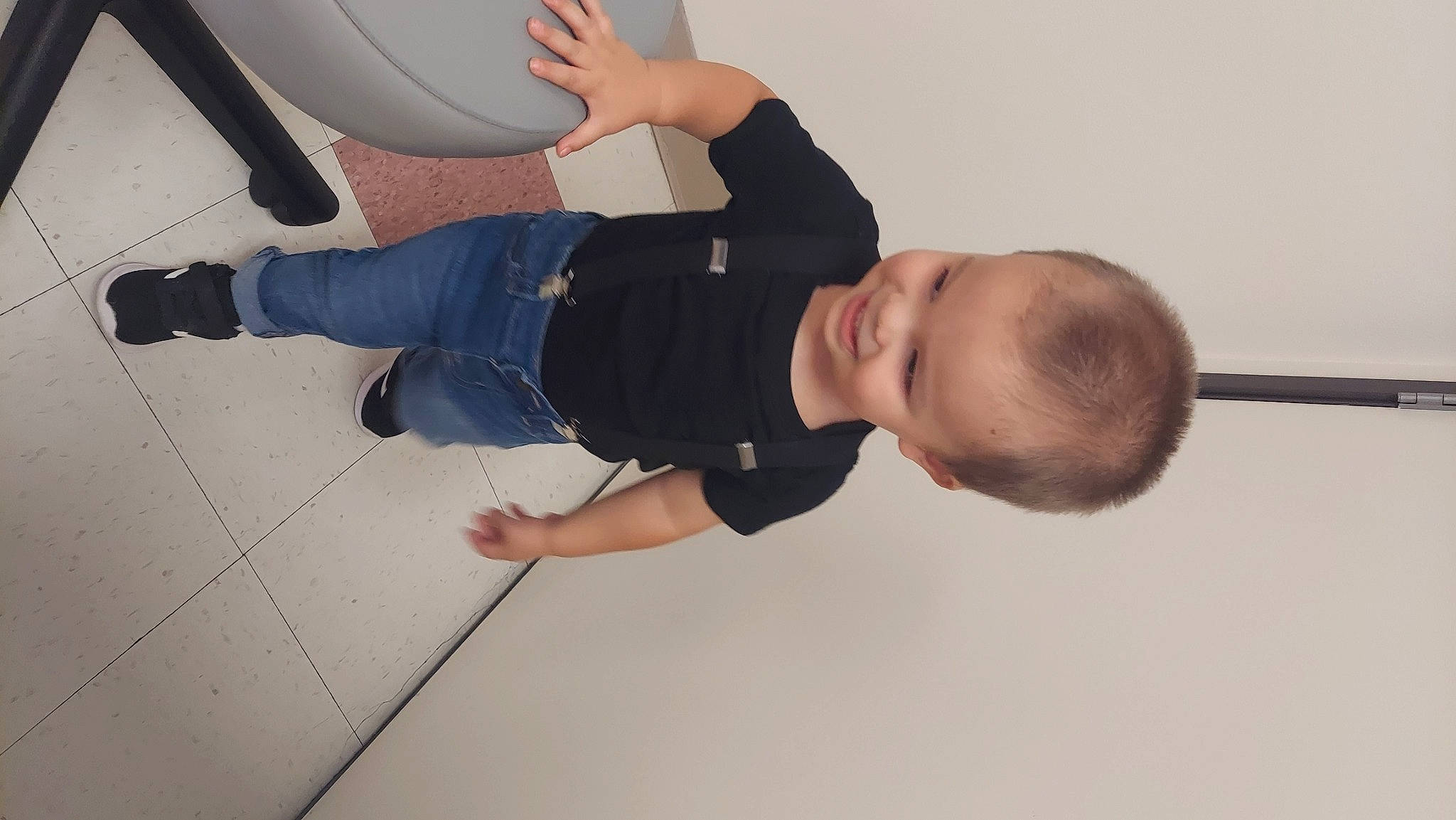 Jason is registered to the contest to win money with this photo: baby, balance, ceiling, child, cleanliness, elbow, flooring, fun, hardwood, human_leg, joint, knee, outdoor_shoe, person, sleeve, t_shirt, thigh, toddler, walking_shoe, wood