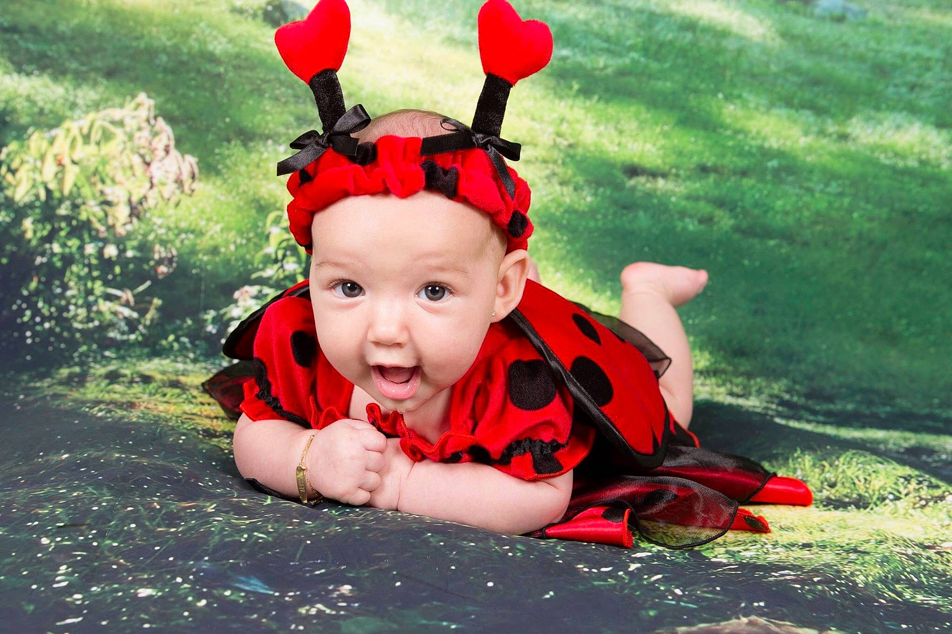 Alyssa is registered to the contest to win money with this photo: child, fun, girl, grass, hair_accessory, happiness, headgear, infant, person, plant, play, red, smile, toddler